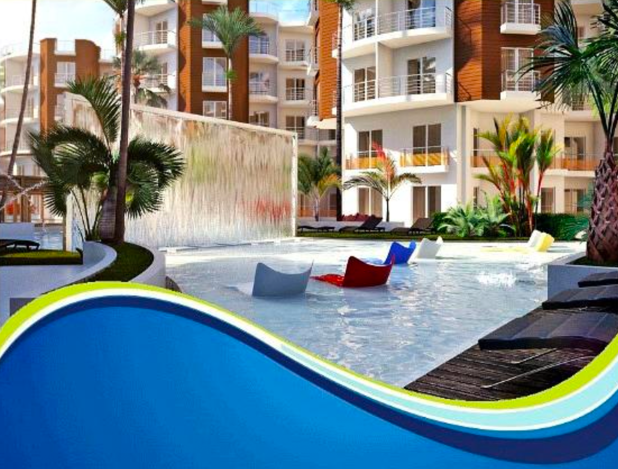 Brochure render — dramatic waterfall wall, floating coloured loungers, sun loungers around the pool perimeter