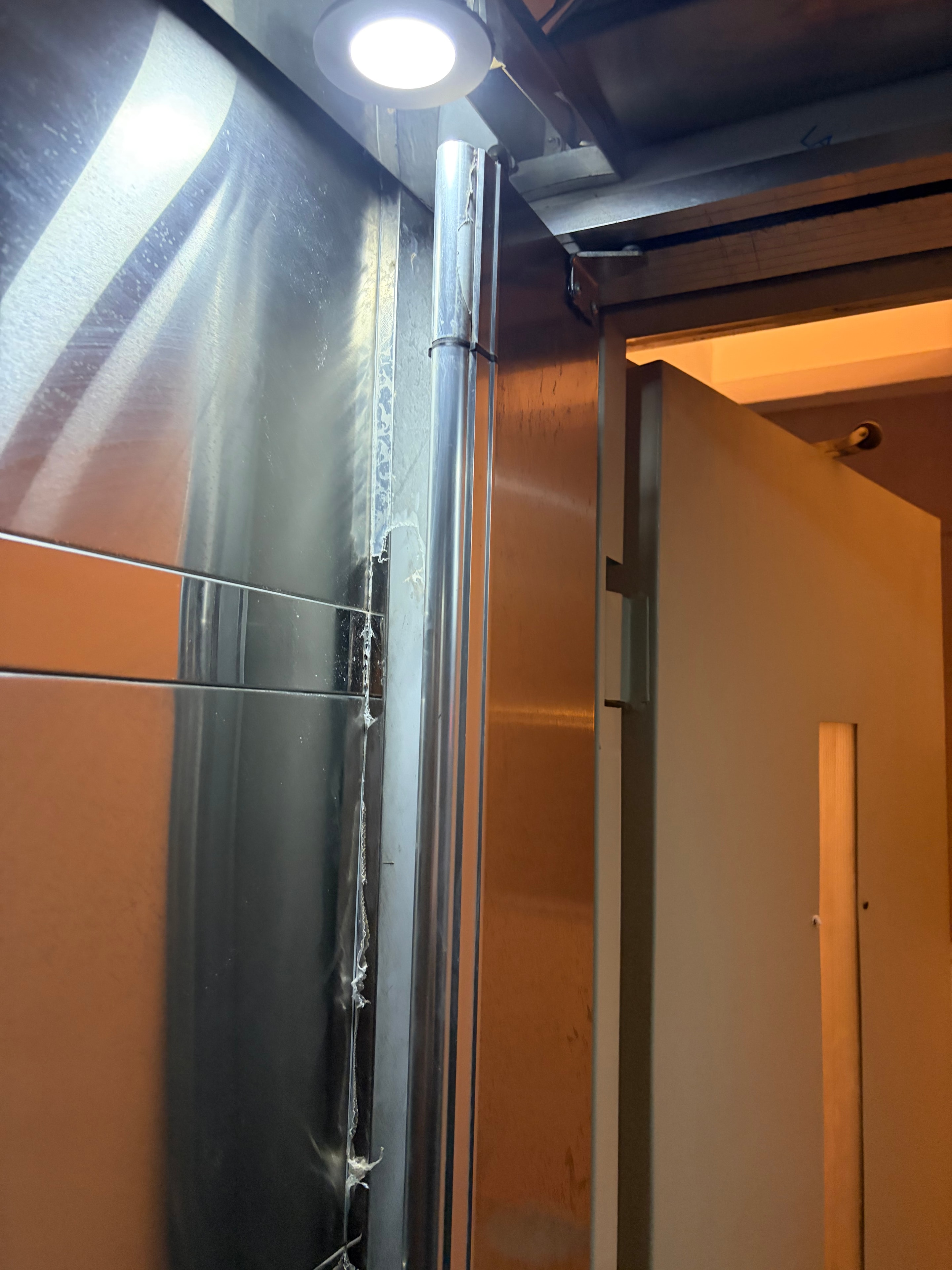Missing inner safety door at top of door frame — door removed entirely leaving shaft accessible