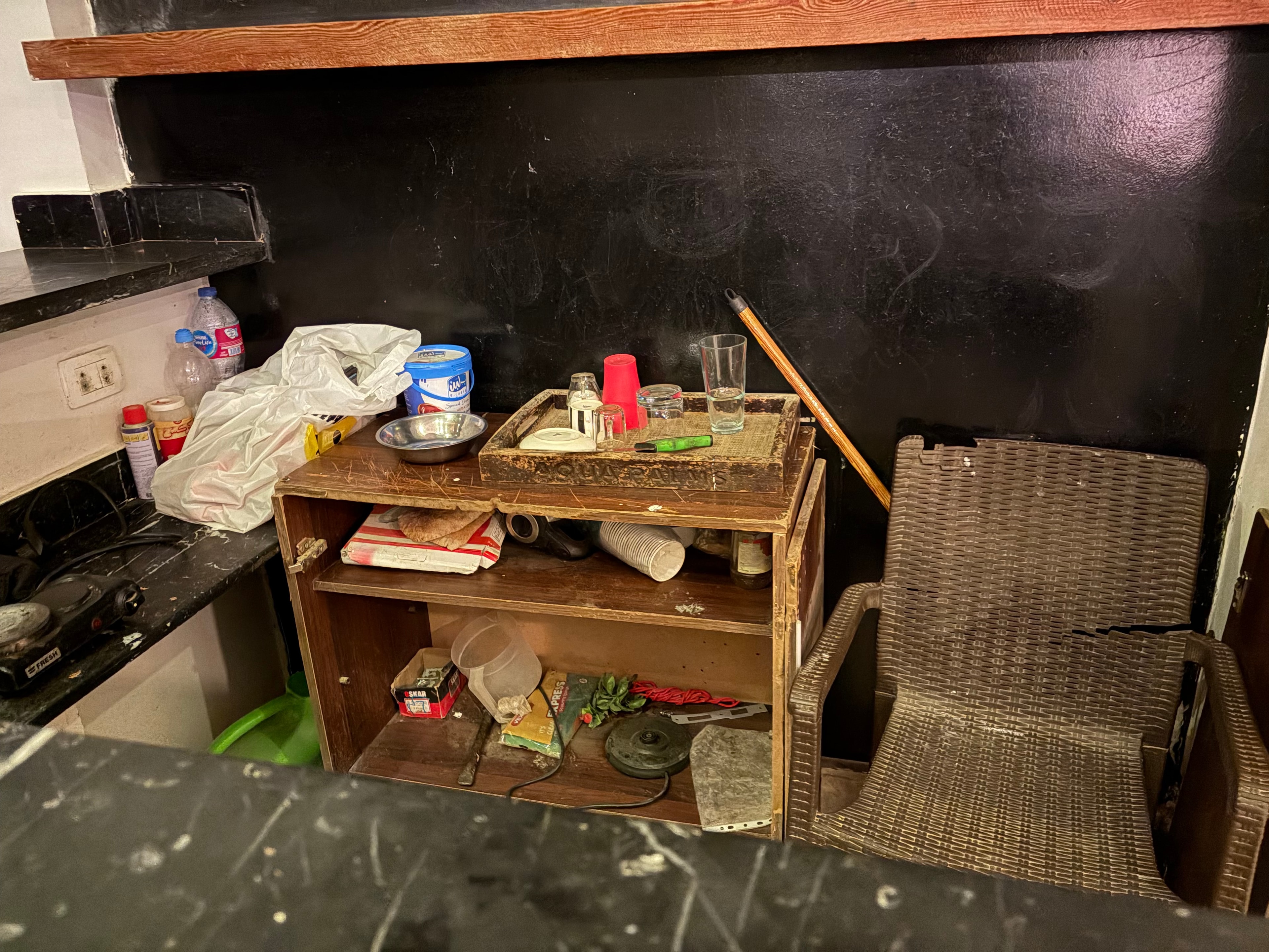 Lobby bar Coffee Corner chalkboard — bare wooden shelves, chalkboard signage, no bar service or stock visible