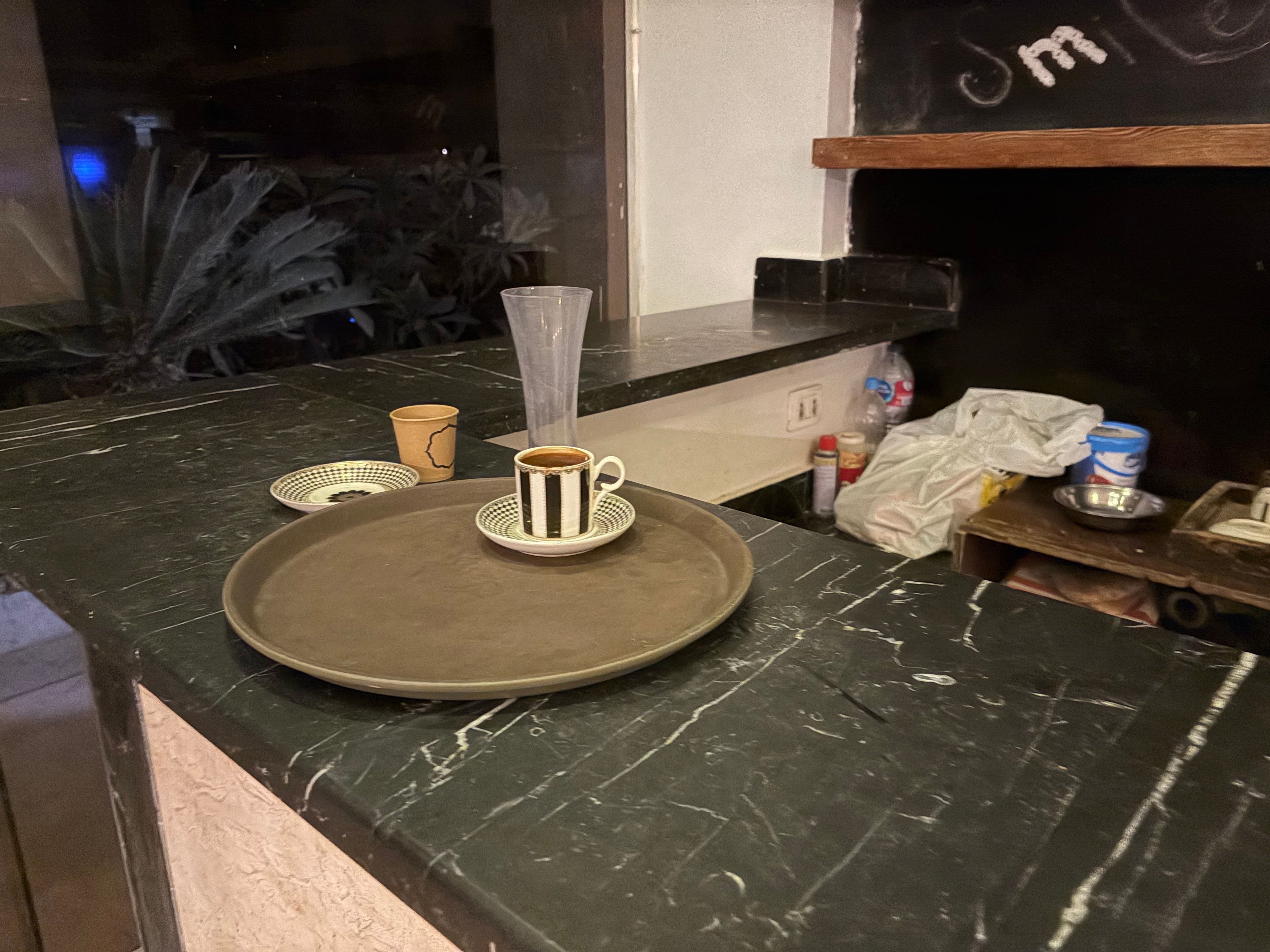 Lobby bar ceiling light fitting with cups and debris balanced on it — fire hazard and completely unacceptable in a resort bar area