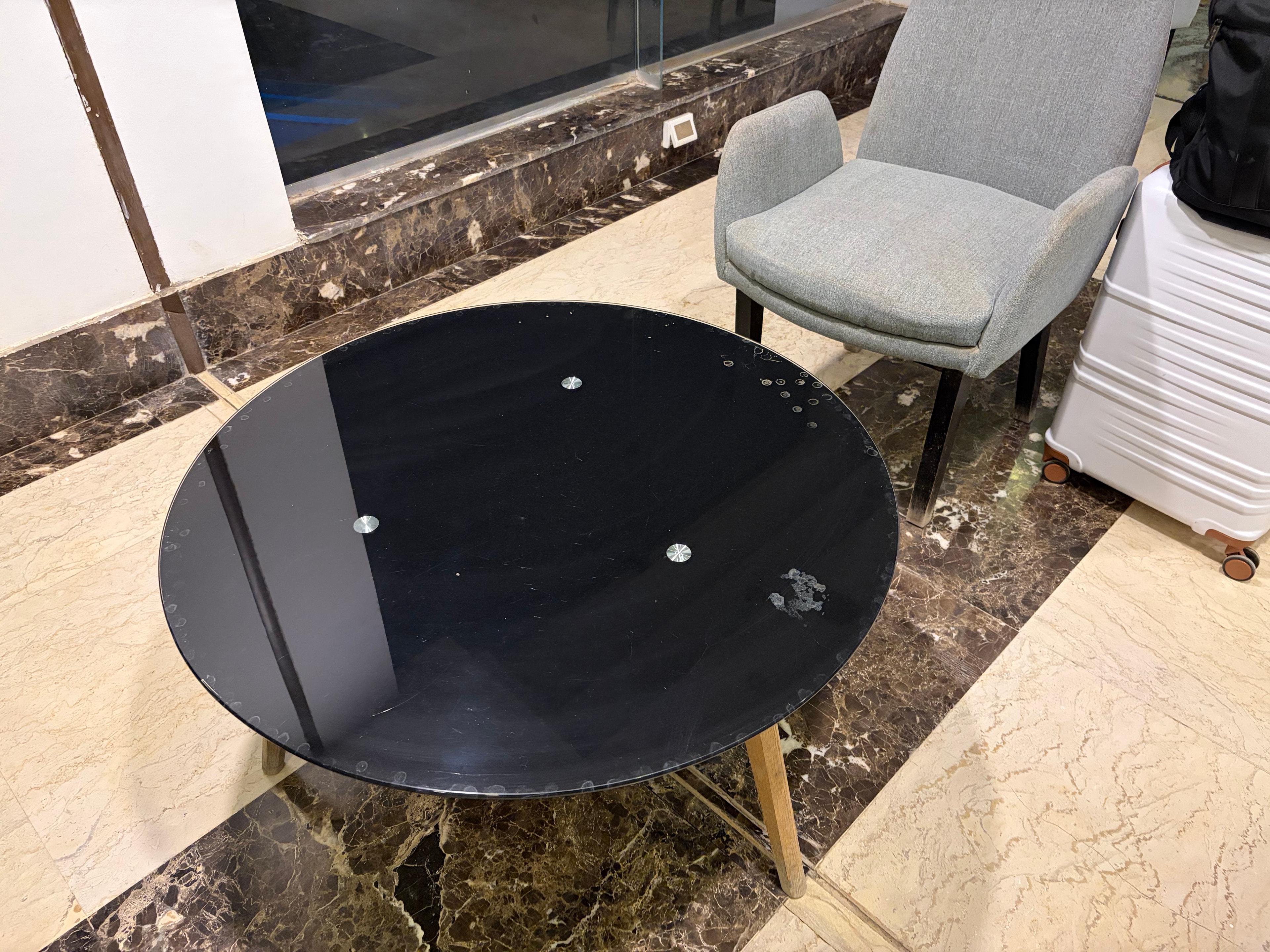 Bare reception desk with exposed ceiling hole and no furnishings