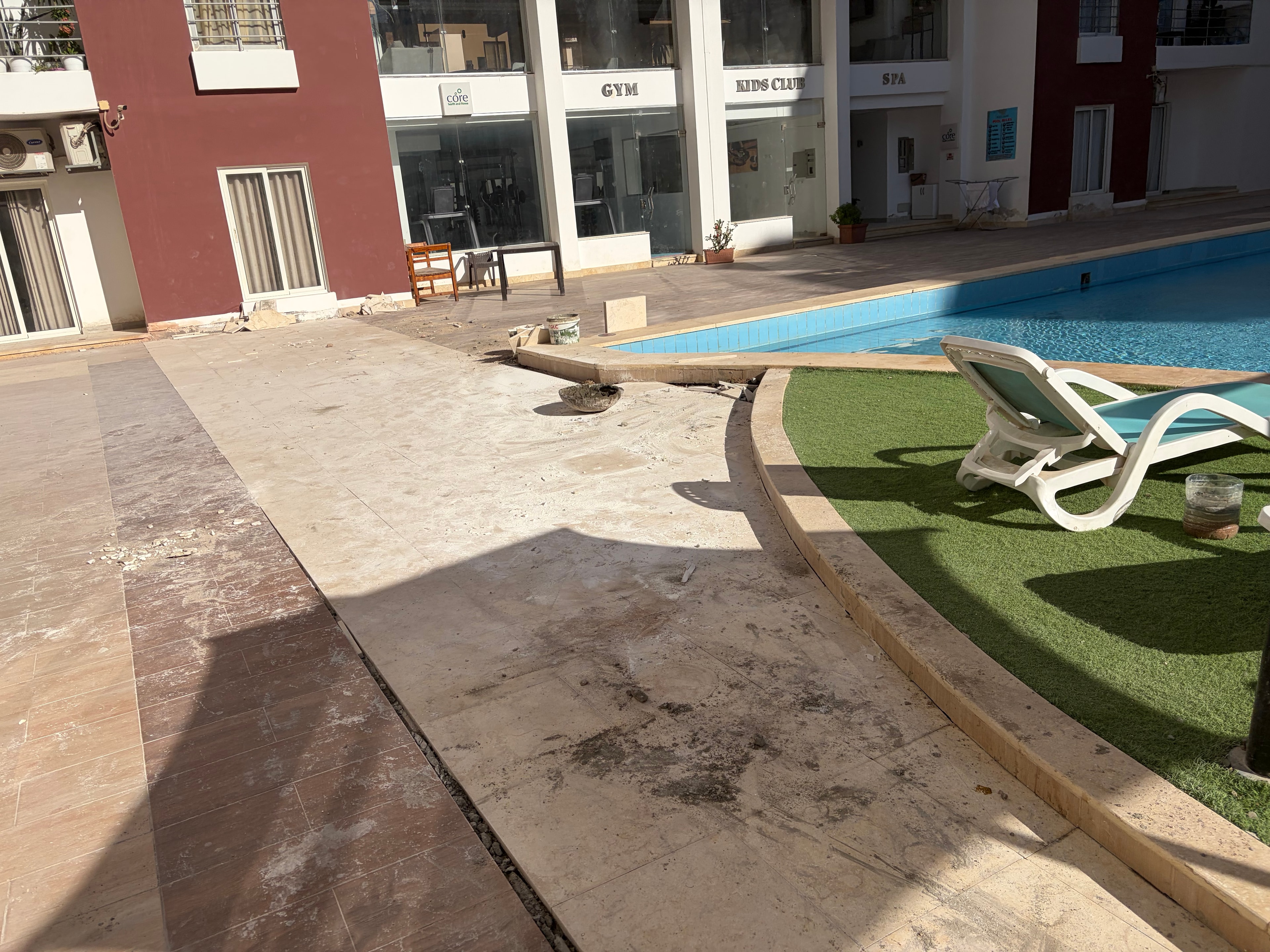 Pool area — mismatched tile repair — poor attempt to repair tile damage using completely different tiles, spoiling the look of the pool area
